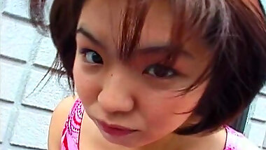 Smiling Asian chick is giving a deep blowjob