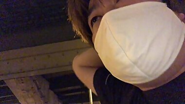 A Fat Man Talking on a Pedestrian Bridge in Osaka