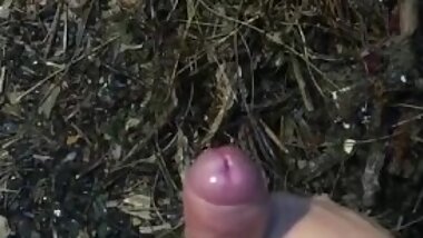 My phimosis penis masturbation by hand in the rainy garden.  The tip of the penis is red