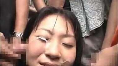 Japanese girl receives a bukkake in public